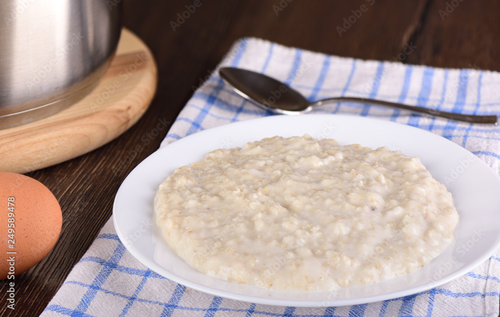 Rustic breakfast with freshly cooked oatmeal and boiled egg