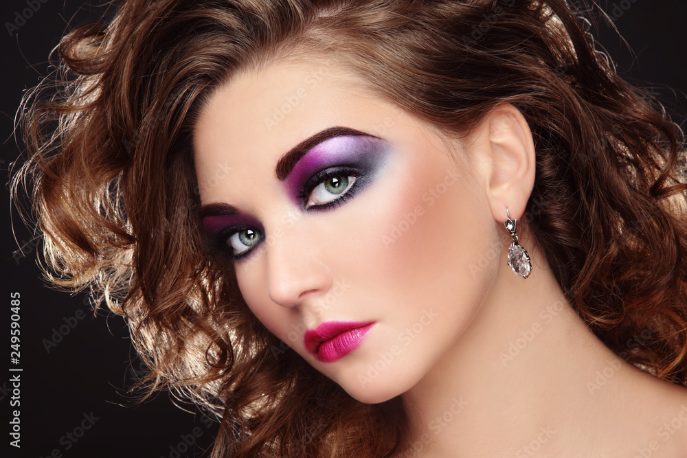 Fototapeta premium Young beautiful girl with glowing colorful disco make-up and curly hair