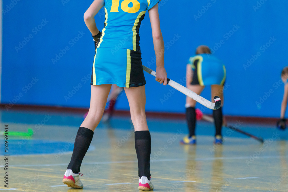 Young girls playing hockey. Indoor hockey training Young girls playing hockey. Indoor hockey training