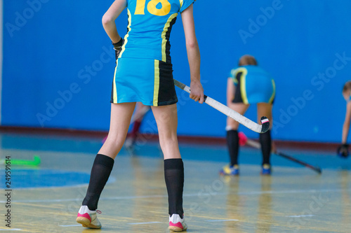 Young girls playing hockey. Indoor hockey training