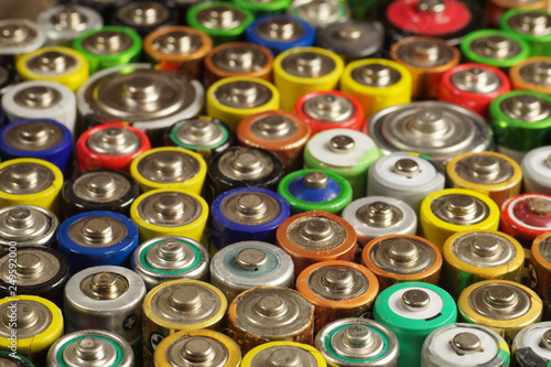 Dozens of types, sizes, colors of used batteries and accumulators. Recycling.