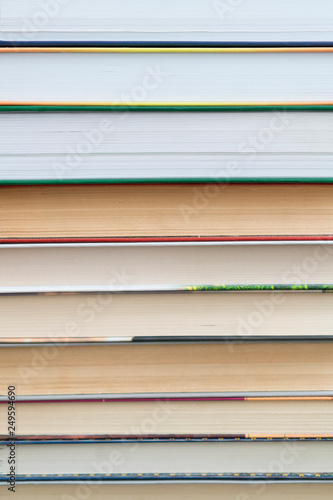 Stack of books background. many books piles. Many Books Piles. Books with color covers. Back to school. vertical photo