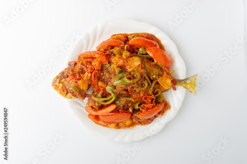 Sweet sour fried fish on white background with selective focus and crop fragment