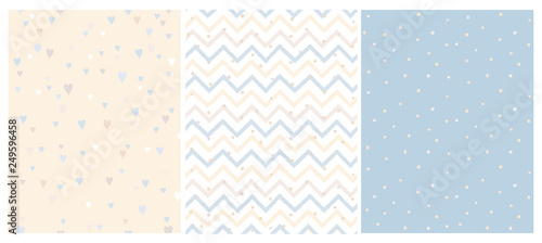 Set of 3 Bright Delicate Chevron, Hearts and Dots Vector Patterns. Irregular Tiny Dots Pattern. Hand Drawn Chevron Designs. White, Yellow, Beige and Blue Pastel Design. Cute Nursery Art Patterns. photo