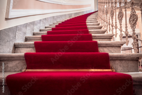фотографія Spiral stairways covered with a red carpet