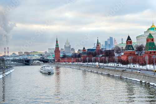 Kremlin embankment ,Moscow Kremlin, Russia, a pleasure boat on the river, city skyline