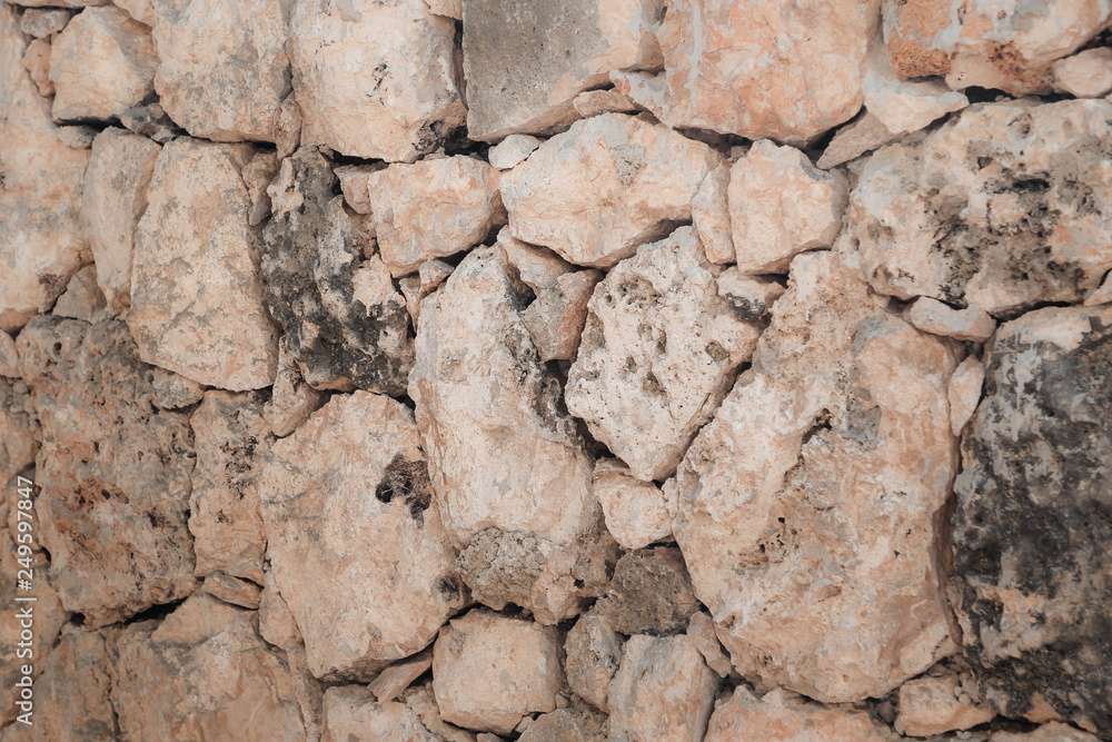 Stone wall of warm tones background Stone wall of warm tones background