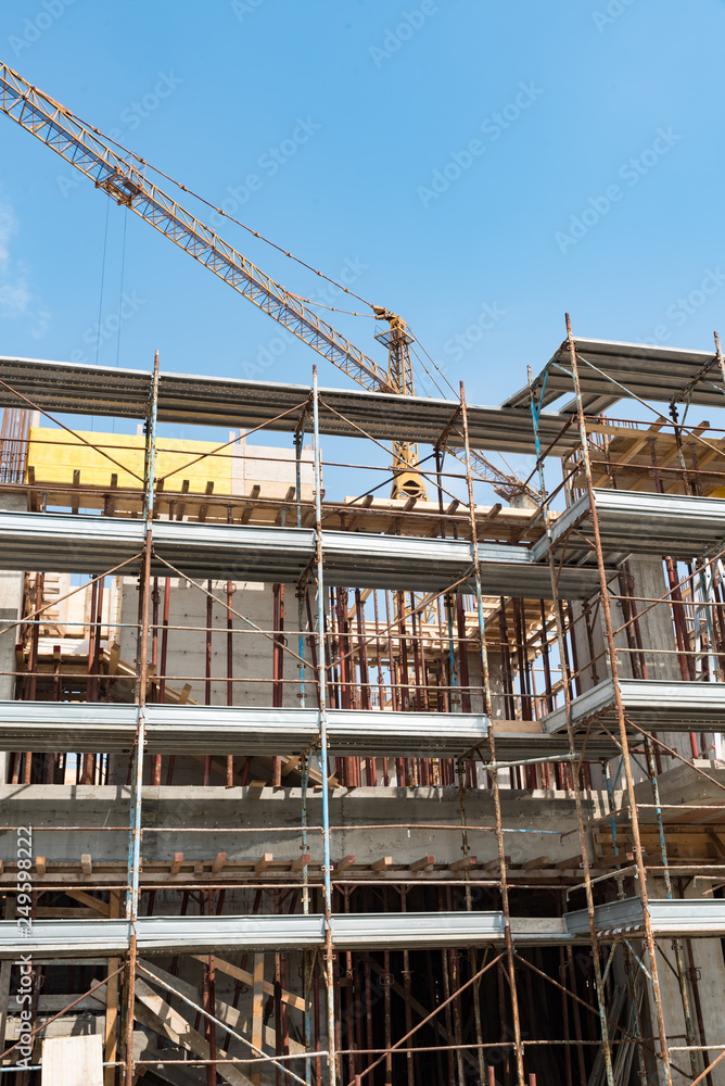 Scaffolds and cranes in a construction site Scaffolds and cranes in a construction site