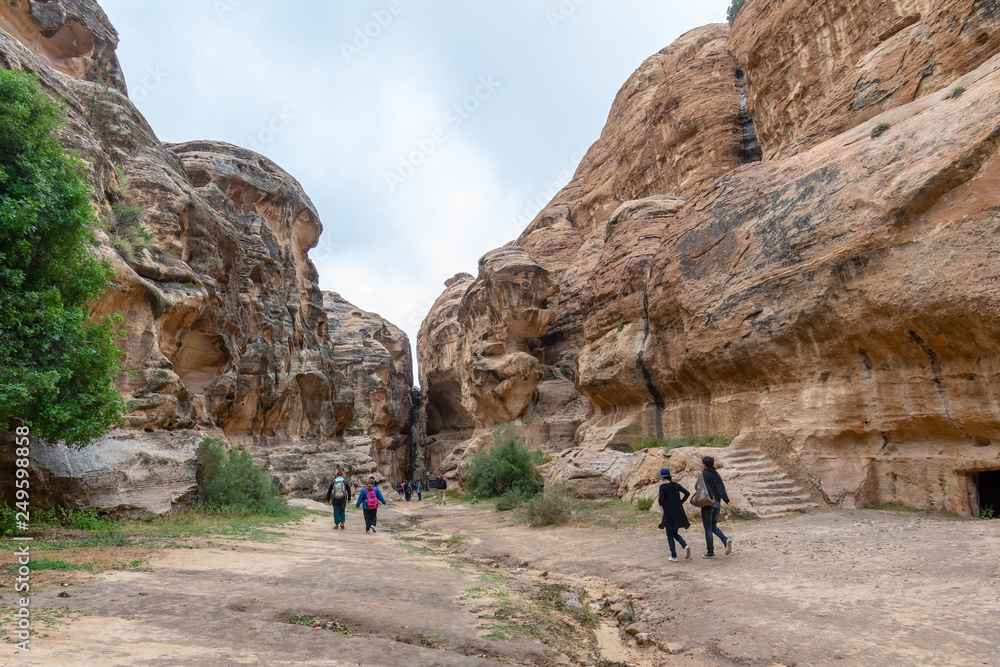 Toursts explore ancient tombs in Little Petra, Jordna Toursts explore ancient tombs in Little Petra, Jordna
