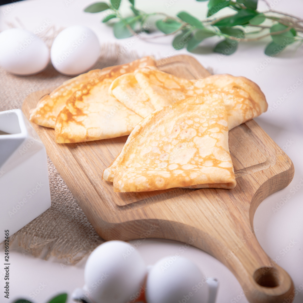 Traditional russian pancakes blini on white background with copy space. Homemade russian thin pancakes blini. Russian food, russian kitchen Traditional russian pancakes blini on white background with copy space. Homemade russian thin pancakes blini. Russian food, russian kitchen
