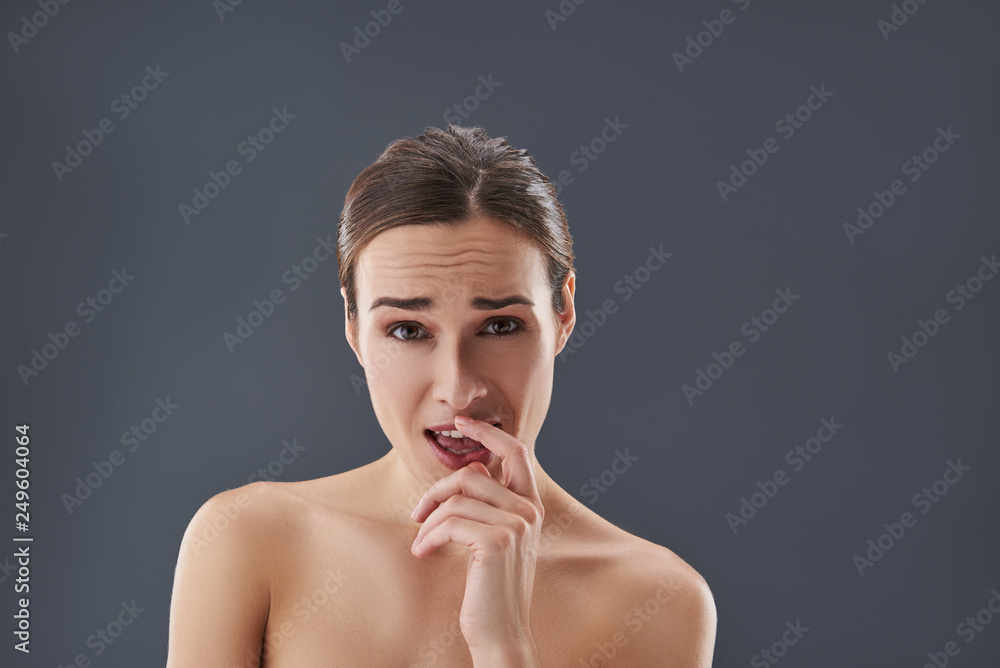 Good-looking lady looking at camera with wide opening mouth Good-looking lady looking at camera with wide opening mouth