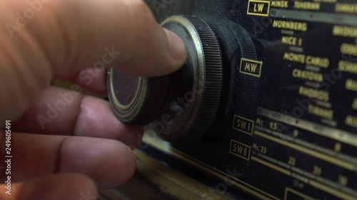 Very Old Vintage dusty Radio, hand turning the Volume Up, Close up shot