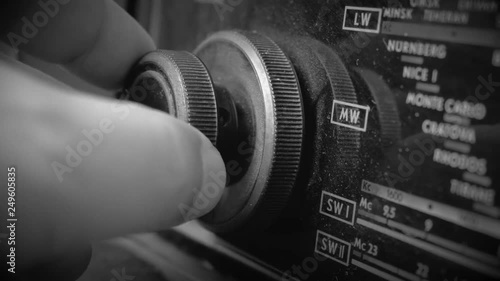 Very Old Vintage dusty Radio, hand turning the Volume all the way Up, Close up shot
