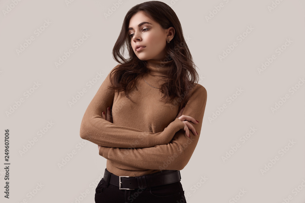 Fashion brunette woman wearing turtleneck and a gold chain Fashion brunette woman wearing turtleneck and a gold chain