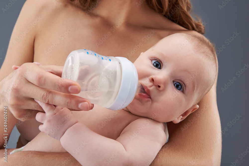 Baby sucking water from plastic transparent bottle Baby sucking water from plastic transparent bottle