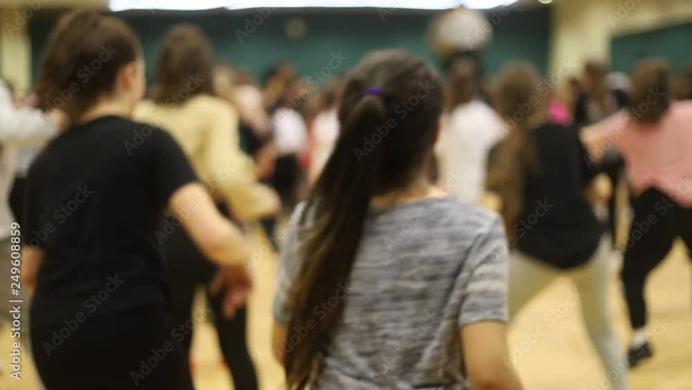 Open dance lesson. A group of people dancing. A girl with dark hair is actively dancing. Open dance lesson. A group of people dancing. A girl with dark hair is actively dancing.