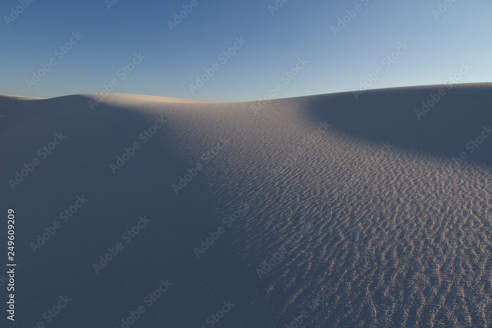 Global warming concept. Sand dunes under evening sunset sky at drought desert landscape