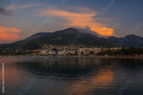 South Europe landscape soft focus view of small city near sea on lonely mountain background in evening twilight time after sunset 