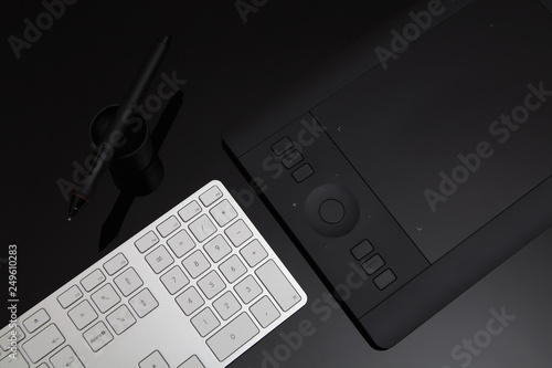 Retoucher and Graphic Designer Desk Concept with Keyboard and Tablet photo