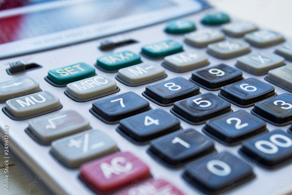 Calculator on white wooden background close-up. Calculator on white wooden background close-up.