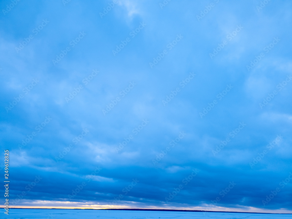 Сlouds in winter on the horizon of a frozen lake. Сlouds in winter on the horizon of a frozen lake.