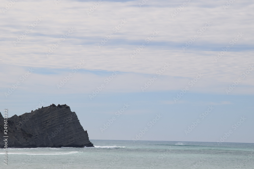 The sea hits the rocks at the shoreline in Gisborne, New Zealand.
