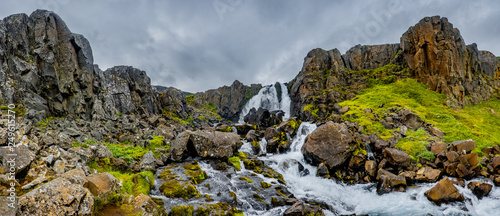 Panoramic view of wilderness of fjord landscape and Selbrekkufoss waterfall near Seydisfjordur on Iceland, summer time