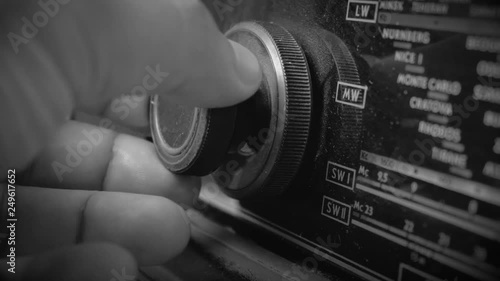 Very Old Vintage dusty Radio, hand turning the Volume Up, Close up shot
