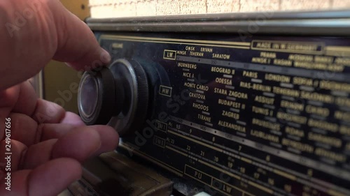 Very Old Vintage dusty Radio, hand turning the Volume Off