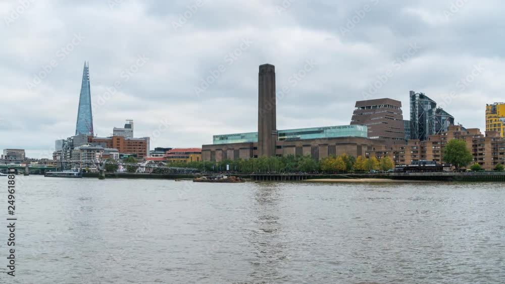 Daytime London cityscape across the River Thames with a view of the Shard, Tate Modern and Millennium Bridge. Daytime London cityscape across the River Thames with a view of the Shard, Tate Modern and Millennium Bridge.