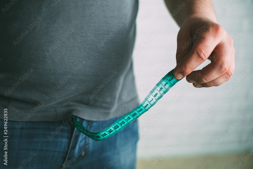 Guy measures penis size with tape measure or tape measure Stock Photo | Adobe Stock