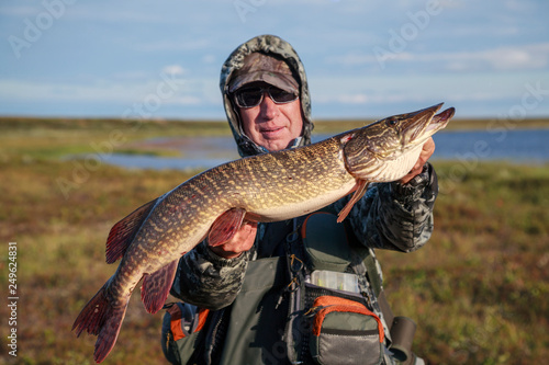The fisherman caught a big pike,