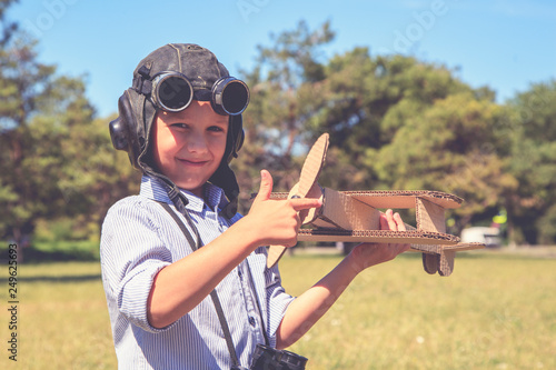 A boy with an airplane, Happy child dreams of becoming a pilot,playing with toy airplane . Retro toned