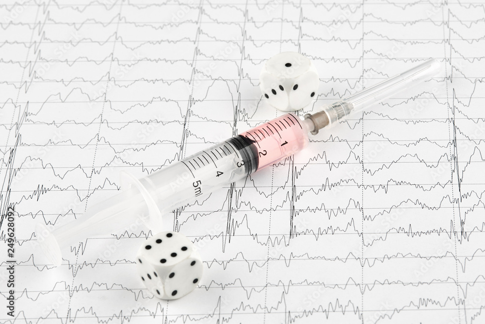 Syringe with medicine and dice on MRI cardiogram Stock Photo Adobe Stock