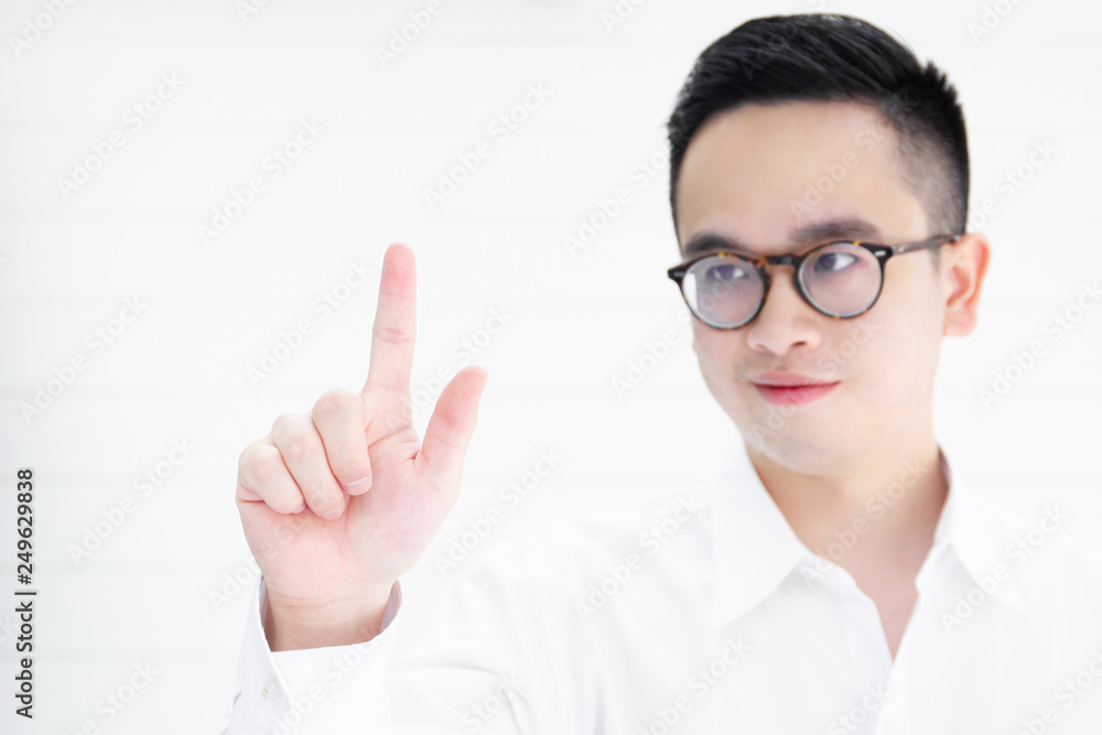 Asian smart and handsom business man in white shirt pointing his finger in the front close up. Asian smart and handsom business man in white shirt pointing his finger in the front close up.