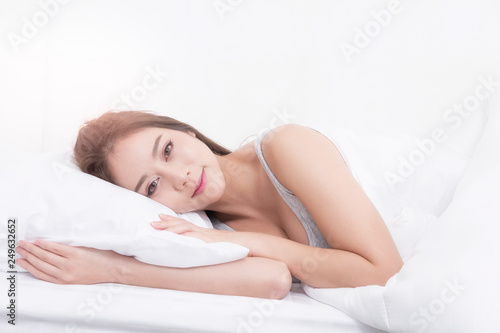 Portrait of a happy woman sleeping in the bed