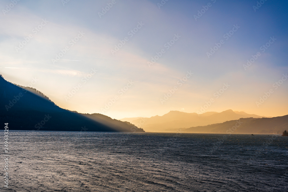 Mountain range illuminated by the oblique rays of the setting sun on the banks of the Columbia River in Colombia Gorge