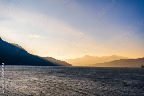 Mountain range illuminated by the oblique rays of the setting sun on the banks of the Columbia River in Colombia Gorge