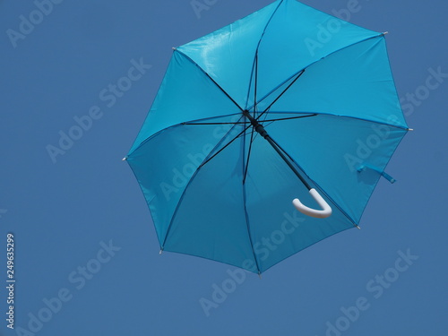 A foldable umbrella rises into blue sky