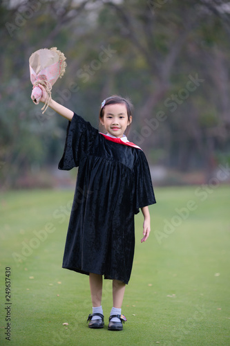 Asian cute child girl graduate. Girl smile on graduation kindergarten uniform