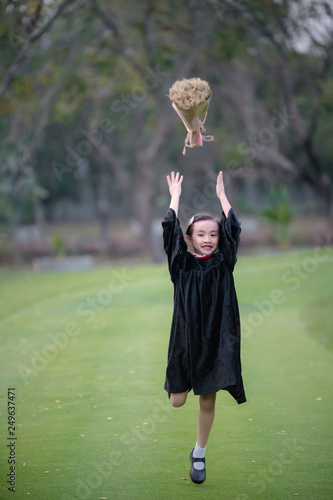 Asian cute child girl graduate. Girl smile on graduation kindergarten uniform