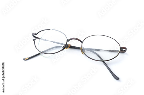 Old glasses with broken brown lens and frame isolated on white background