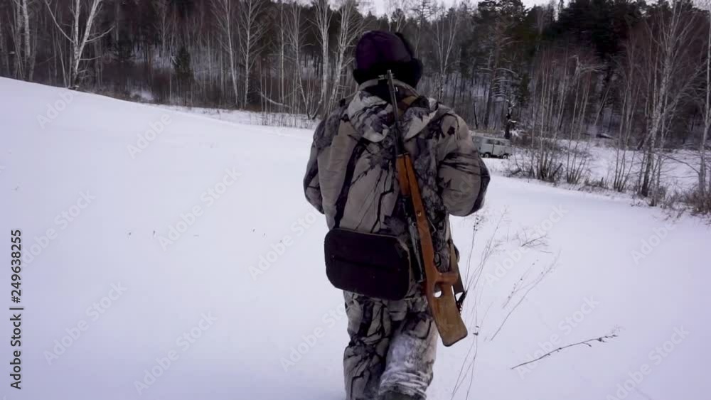 Hunters in the Woods. Armed Rangers in winter forest Hunters in the Woods. Armed Rangers in winter forest