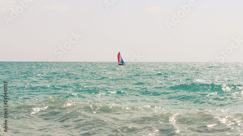 lonely sailboat is on the Pacific Ocean
