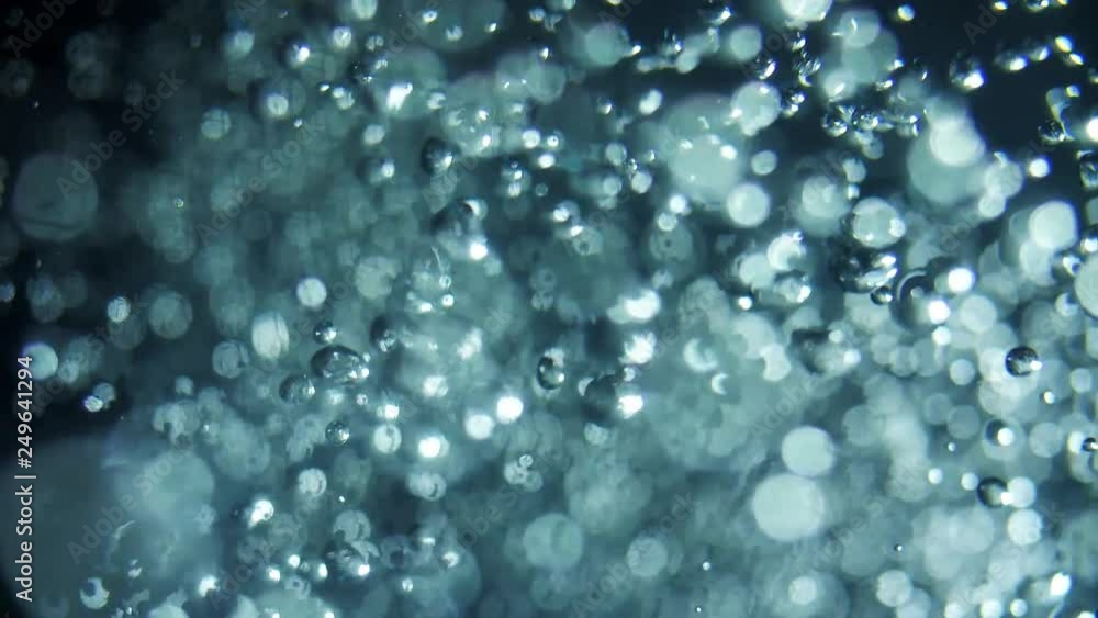 Moving magic particles like a bubbles, shimmering on a black background. Abstract background with moving and flicker particles. Backdrop of bokeh. Moving magic particles like a bubbles, shimmering on a black background. Abstract background with moving and flicker particles. Backdrop of bokeh.