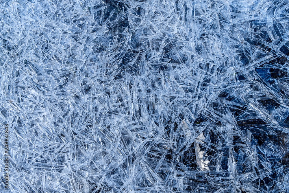 close up of dense ice crystal filled pond surface texture background on cold winter day close up of dense ice crystal filled pond surface texture background on cold winter day