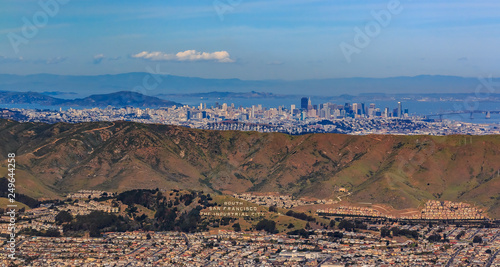 Aerial view of downtown San Francisco and Financial District sky scrapers flying over South San Francisco The Industrial City inscription on San Bruno mountain circa 2015
