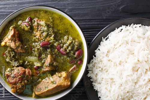 Fotografie Persian national food meat stew with herbs and beans close-up in a bowl served with steam rice