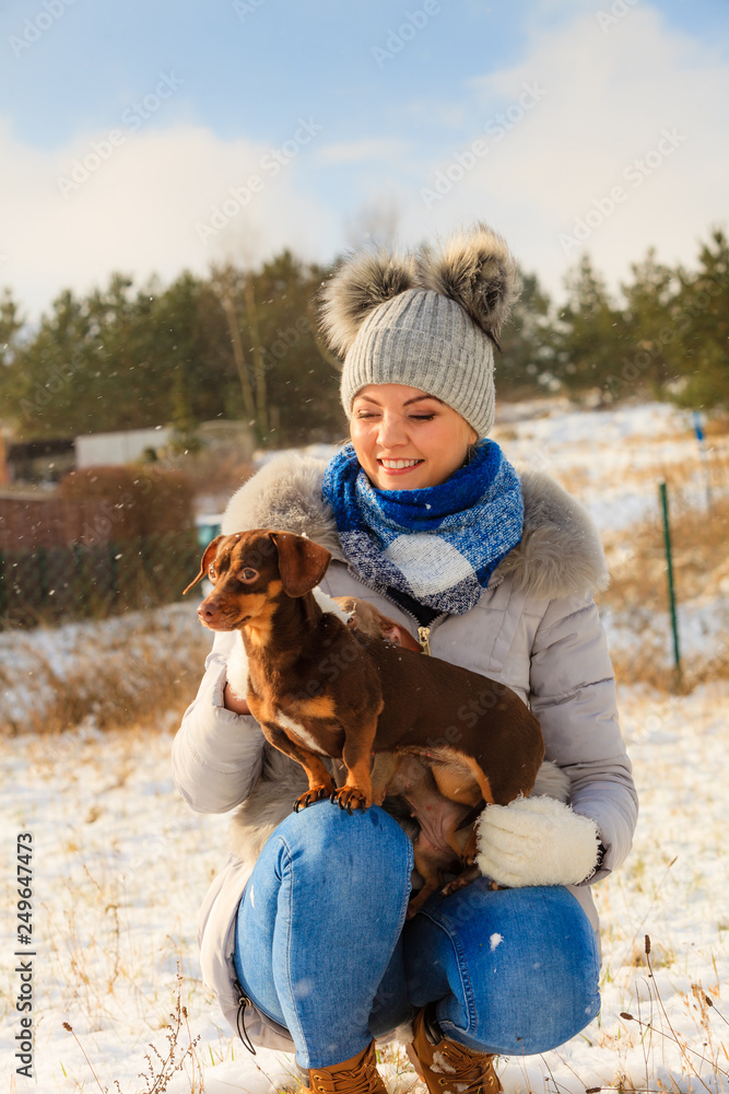 Woman playing with dogs during winter Woman playing with dogs during winter
