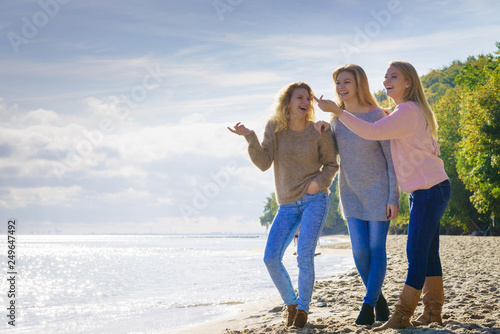 Three fashionable models pointing outdoor